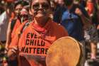 Activists, many wearing orange shirts, take to the streets of Toronto in June to mark the discovery of unmarked graves at residential schools.