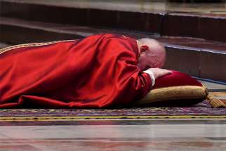 Pope Francis lies prostrate as he leads the Good Friday Liturgy of the Lord&#039;s Passion April 2, 2020, at the Altar of the Chair in St. Peter&#039;s Basilica at the Vatican.