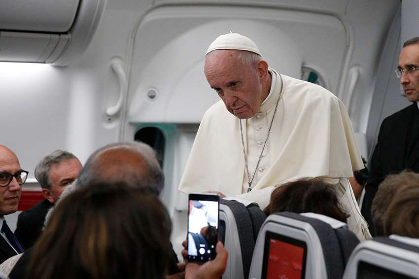 Pope Francis listens to a question from a journalist aboard his flight from Panama City to Rome, Jan. 27, 2019. 