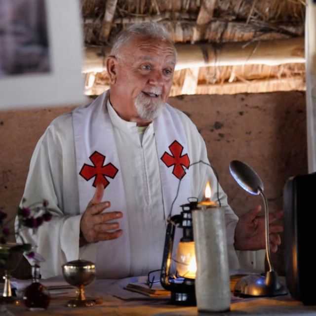 Italian Comboni Father Mario Benedetti celebrates a Sept. 30 Mass in the chapel of the Makpandu refugee camp in a remote section of South Sudan. More than 3,000 people live in the camp, having fled Congo in 2008 when the Lord&#039;s Resistance Army started a murderous rampage through the area. Father Benedetti accompanied the refugees to the camp when they fled Congo. 