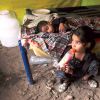 Children from a Christian neighbourhood in Lahore, Pakistan, whose house was burned by a Muslim mob, take refuge in a tent.