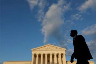 A person walks past the U.S. Supreme Court building in Washington May 13, 2021.