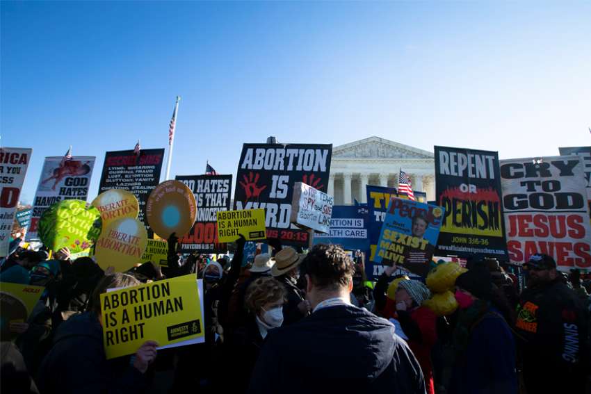 People in Washington gather outside the U.S. Supreme Court Dec. 1, 2021, the day justices heard oral arguments in a case about a Mississippi law that bans abortions after 15 weeks of gestation.