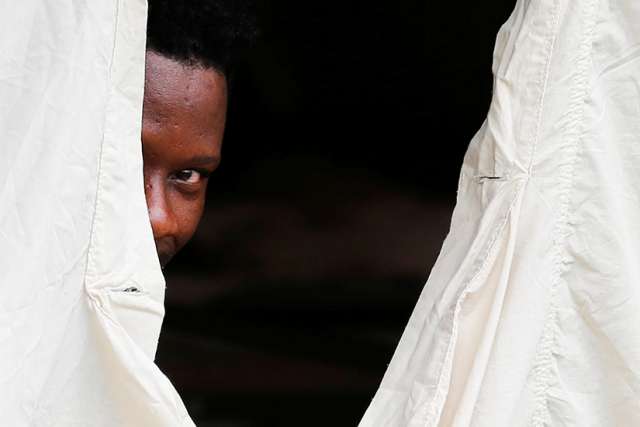 A Haitian refugee takes shelter in a tent set up by the Canadian Armed Forces near Lacolle, Quebec, Aug. 10.