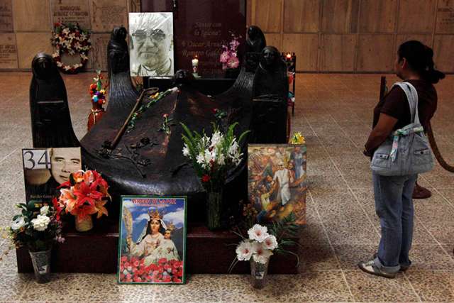 In this file photo, a tourist visits the tomb of Archbishop Oscar Romero in San Salvador.