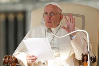 Pope Francis holds up five fingers to represent the Fifth Commandment as he speaks during his general audience in St. Peter&#039;s Square at the Vatican Oct. 10.