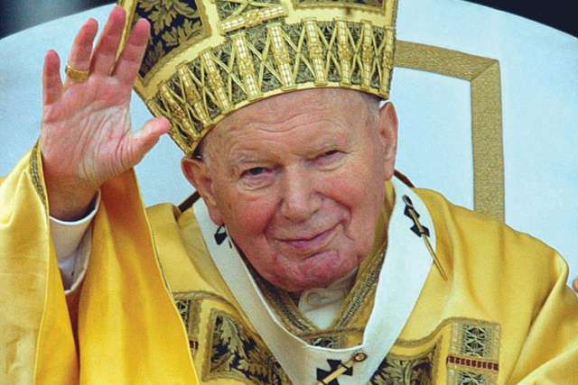 Blessed John Paul II greets the crowd gathered in St. Peter’s Square at the Vatican in this Dec. 25, 2002, file photo.
