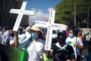 Relatives of civil war victims commemorate the 30th anniversary of the signing of the peace accords that ended El Salvador’s war in San Salvador, El Salvador, Jan. 16.