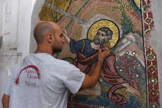 A worker from the Piacenti restoration center works on a mosaic in the Church of the Nativity July 5 in Bethlehem, West Bank. Restoration specialists from the center completed their work in June.