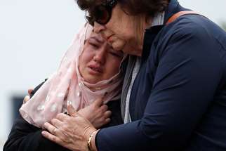 People embrace as they pay respects outside Al Noor Mosque in Christchurch, New Zealand March 18, 2019. Prayer services were held across the country and abroad after March 15 mosque attacks in Christchurch that left at least 50 people dead and 20 seriously injured. 