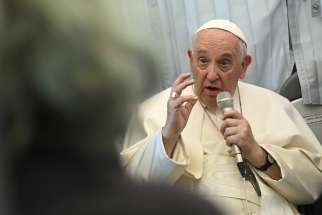 Pope Francis responds to questions from journalists during his flight from Hungary back to Rome April 30, 2023.