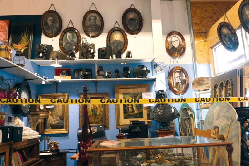 Historical Catholic artifacts are seen among other items in a booth at the Rocky Mountain Antique Mall in Edmonton, among them a bust of St. Eugene de Mazenod, right, that was on sale for $380.