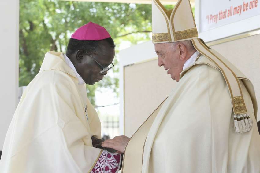 Pope Francis greets Archbishop Stephen Ameyu Martin Mulla of Juba, South Sudan, as the pontiff celebrates Mass at the John Garang Mausoleum in Juba Feb. 5, 2023. The pope announced during his July 9 Angelus that Archbishop Ameyu Mulla will become a cardinal.