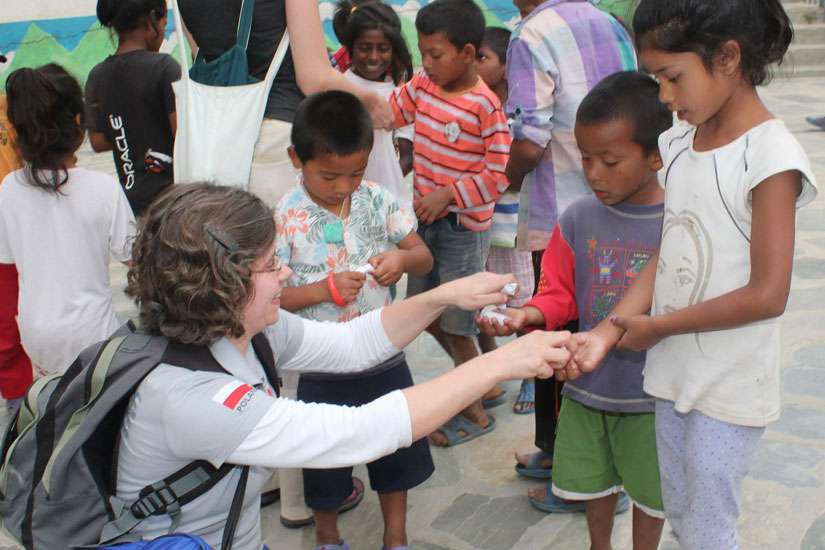 Marta Titaniec, projects coordinator of Caritas Poland, distributes sweets to inmates of the Children’s Home for prisoners’ children at Sankhu village outside Kathmandu, Nepal, May 7. Caritas Poland has brought a Polish air force plane with more than 14,500 kilograms of relief material for the victims of the April 25 Nepal earthquake. 