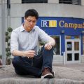 Perched upon a rock on campus, Ryerson student Kevin Lo prays the rosary to connect with God, his new foundation.