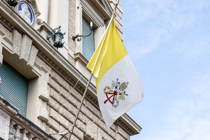 A Vatican City flag, slightly different from the official version, waves outside the Jesuit headquarters in Rome June 1, 2023.