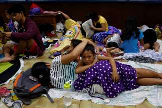  Residents of La Union, Philippines, take shelter at an evacuation center in San Fernando Oct. 19. Heavy damage was reported to homes and farmland in the northern Philippines Oct. 20 after the strongest storm in three years struck overnight.