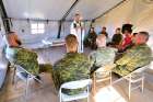 Padre Tim Nelligan, Senior Chaplain from Edmonton, presides over the holy Mass at Airfield 21 in Wainwright, Alta. Chaplains are the sounding board for soldiers who are dealing with the demons from their service.
