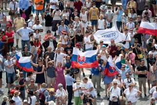 Pilgrims holding the Slovak flag cheer in St. Peter&#039;s Square at the Vatican July 4, 2021, as Pope Francis announces he will visit their country Sept. 12-15 after stopping in Budapest, Hungary, to celebrate the closing Mass of the International Eucharistic Congress.