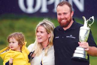 Irish golfer Shane Lowry poses with his wife, Wendy, and daughter, Iris, after winning the Open Championship July 21.