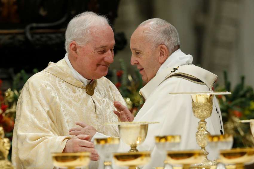 Pope Francis greets Cardinal Marc Ouellet during the sign of peace at a Mass in St. Peter’s Basilica at the Vatican in this Jan. 6, 2020, file photo.