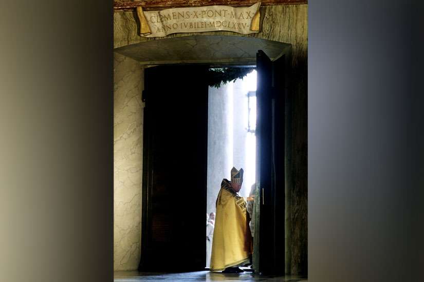 St. John Paul II pushes open the Holy Door and walks into St. Peter&#039;s Basilica on Christmas Eve 1999. Opening a sealed Holy Door is one of the traditions that usually marks a Holy Year.