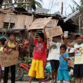 Young residents in Cebu, Philippines, hold signs asking for help and food along the highway Nov. 11 after Super Typhoon Haiyan hit. The typhoon, one of the strongest storms in history, is believed to have killed tens of thousands, but aid workers were st ill trying to reach remote areas.