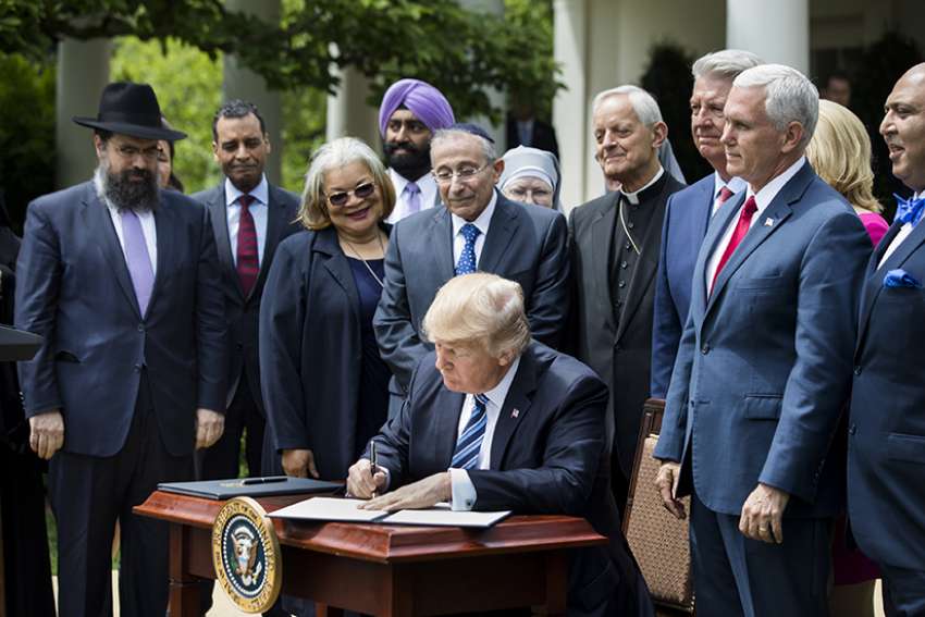 President Donald Trump signs his Executive Order on Promoting Free Speech and Religious Liberty during a National Day of Prayer event at the White House in Washington May 4.