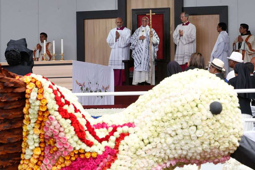 Pope Francis told students and educators at the Pontifical Catholic University of Ecuador July 7 that humans were invited to grow and protect creation. A floral hummingbird is seen as the Pope celebrates Mass in Bicentennial Park in Quito, Ecuador.