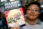 A woman displays the last of a series of seven Harry Potter books by British author J.K. Rowling titled &quot;Harry Potter and the Deathly Hallows,&quot; in 2007 in Bangkok. June 26 was a day to remember for Harry Potter fans old and new as it marked 20 years since the iconic &quot;Harry Potter and the Philosopher&#039;s Stone&quot; was first published.