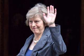 British Home Secretary Theresa May waves as she arrives July 12 to attend the last Cabinet meeting hosted by British Prime Minister David Cameron. Cardinal Vincent Nichols of Westminster said he is delighted by the appointment of May as Britain&#039;s new prime minister because of the commitment she has shown in the fight against human trafficking.