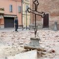 Officers stand near a cross that fell from a church in Crevalcore near Bologna, Italy, May 20. A strong earthquake rocked a large portion of northern Italy early that day, killing at least seven people and causing serious damage to centuries-old cultural sites. 