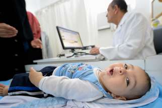A Palestinian baby receives medical attention in Gaza City 2015. 