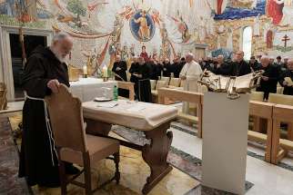 Capuchin Father Raniero Cantalamessa, left, preacher of the papal household, prepares to give the last of his Friday Lenten meditations for Pope Francis and members of the Roman Curia in the Redemptoris Mater Chapel at the Vatican March 23.
