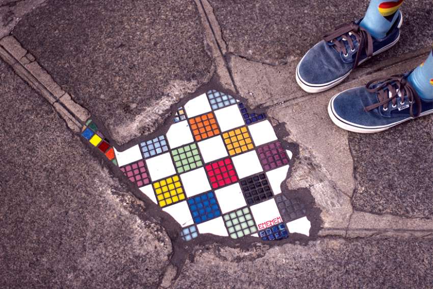 French artist Ememem, the “Pavement Surgeon,” is repairing holes in sidewalks and roads, turning them into exquisite tilework art pieces.