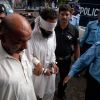 Police escort blindfolded Muslim cleric Khalid Jadoon Chishti as he is taken into court in Islamabad Sept. 2. Pakistani authorities arrested the imam on suspicion of framing Rimsha Masih, a Pakistani Christian girl accused of blasphemy. Those charges were dropped Nov. 19. 