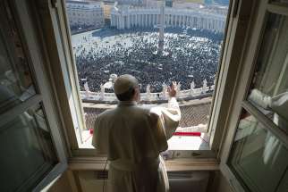 Pope Francis greets the crowd as he leads the Angelus from his studio overlooking St. Peter&#039;s Square at the Vatican Jan. 29. 