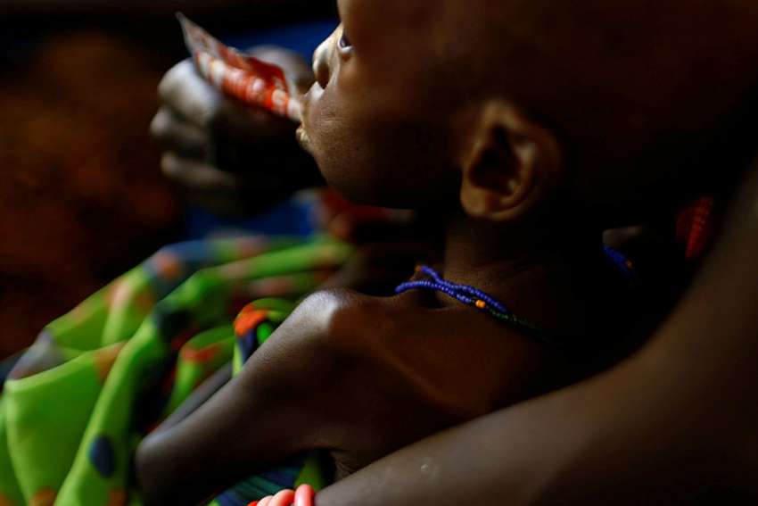 A mother feeds her child with a peanut-based paste for treatment of severe acute malnutrition at a hospital Jan. 20 in Juba, South Sudan.