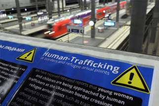 An information board with a warning about human trafficking at borders and refugee arrival points is seen at the central railway station in Berlin March 16, 2022.