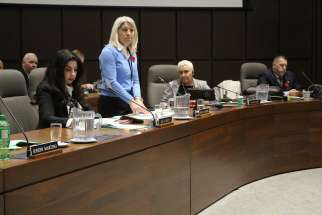 Teresa Lubinski addresses her fellow trustees at the Toronto Catholic District School Board meeting while Ida Li Preti, left, and chair Maria Rizzo look on. 