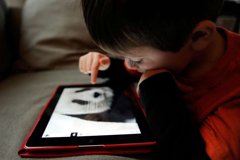 A boy uses the World Wildlife Fund app to take a closer look at pandas on an iPad in early March. The American Academy of Pediatrics issued a new policy statement Oct. 28 on the dangers of too much screen time for children. 