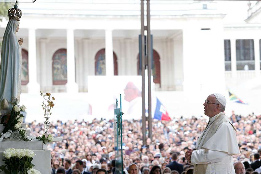 Pope Francis prays in the Little Chapel of the Apparitions at the Shrine of Our Lady of Fatima in Portugal, May 12. The pope was making a two-day visit to Fatima to commemorate the 100th anniversary of the Marian apparitions and to canonize two of the young seers.