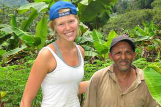 An Intercordia student and her host father on the cunuco or plantation in the Dominican Republic.