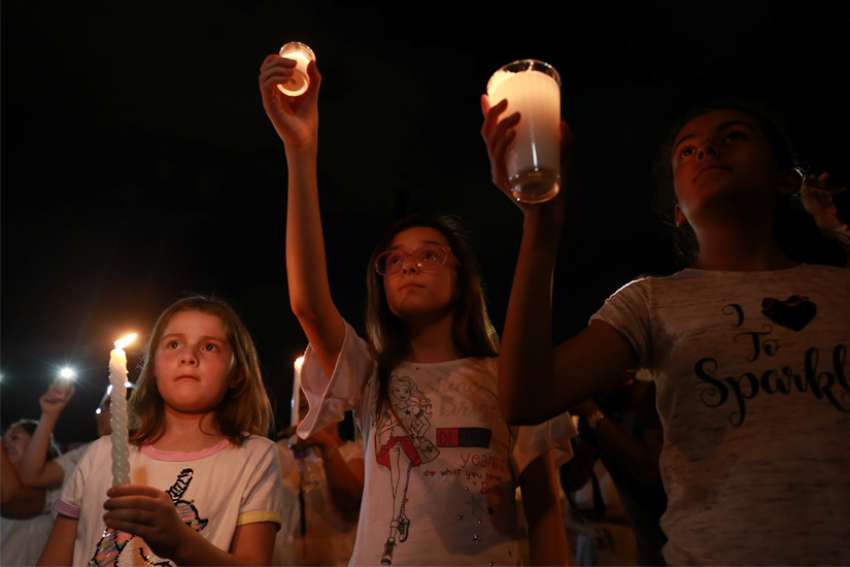 Mourners take part in a vigil near the border fence between Mexico and the U.S. after a mass shooting at a Walmart store in El Paso, Texas, Aug. 3, 2019. The Catholic dioceses of El Paso, and neighboring Las Cruces, New Mexico, have joined in prayer after the shooting left several dead and many injured.
