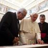 Pope Benedict XVI exchanges gifts with Palestine&#039;s President Mahmoud Abbas during a private audience in the pontiff&#039;s library at the Vatican Dec. 17. A statement from the Vatican press office said the two leaders discussed the need to restart talks betwe en the Israelis and Palestinians.