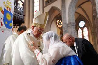 Pope Francis embraces a former sex slave, or comfort woman, as he celebrates a Mass for peace and for the reconciliation of North and South Korea at Myongdong Cathedral in Seoul, South Korea, Aug. 18.