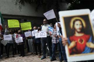 People pray outside the Nicaraguan Embassy in Mexico City Aug. 16, 2022. They were demanding respect for religious freedom in Nicaragua and an end to the persecution of the church and opponents of the government of Nicaraguan President Daniel Ortega.