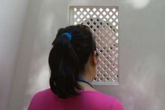 A young woman is pictured in a file photo during confession. New laws passed by Queensland Parliament in Australia Sept. 8, 2020, mean religious institutions and their members are no longer able to use the seal of the confessional as a defense or excuse in child sex abuse matters.