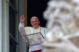 Pope Francis waves as he leads the Angelus from the window of the Apostolic Palace in St. Peter&#039;s Square at the Vatican June 15. The pope expressed his fears over increasing violence in Iraq and prayed for peace, security and reconciliation in the country.