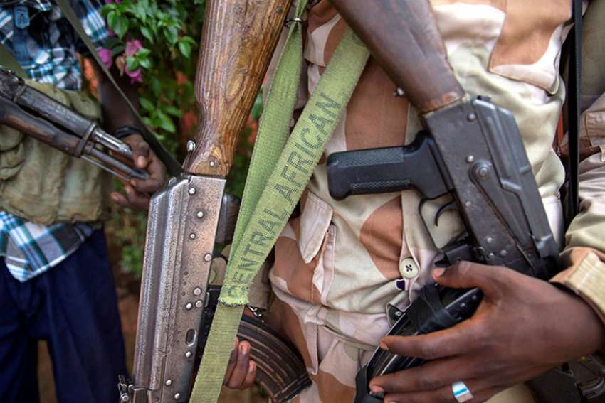 Armed militia fighters display weapons in the town of Koui, Central African Republic, on April 27, 2017. 